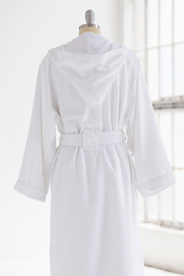 Close up of the back of a belted, white, hooded robe on mannequin against a white background.