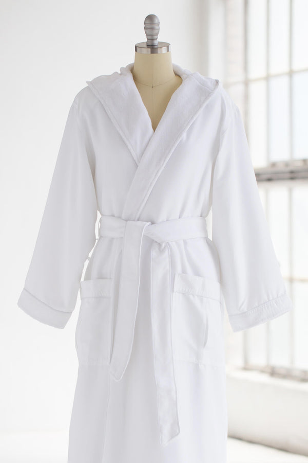 Close up of the front of a white, hooded robe on mannequin against a white background.