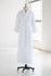 White, tall, terry cloth robe on mannequin with a white background.